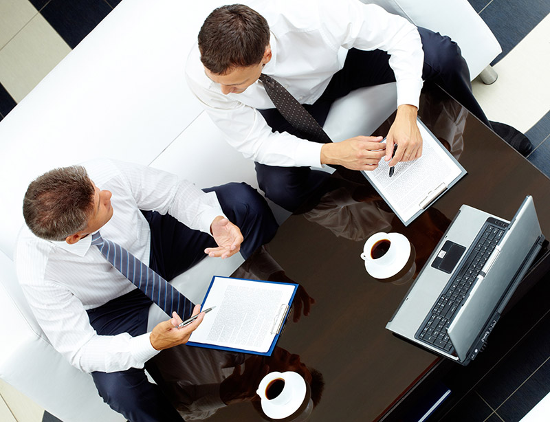 Image of two business partners discussing work at meeting